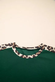 Green polyester tee with leopard print raglan sleeves and neckline detail.