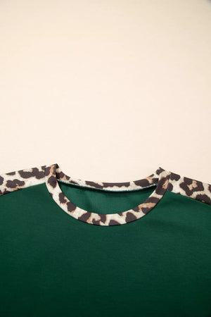 Green polyester tee with leopard print raglan sleeves and neckline detail.