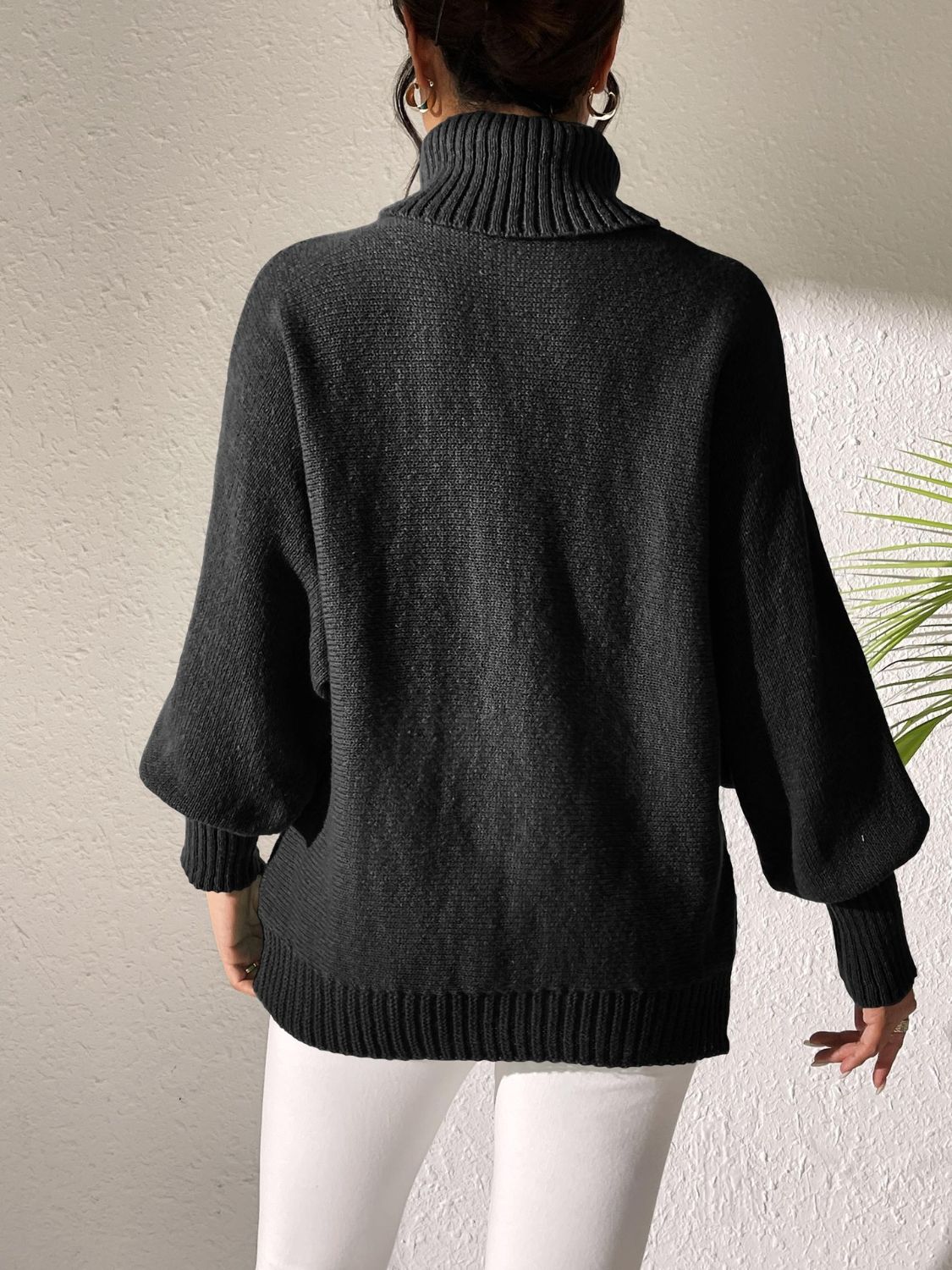 Black turtleneck sweater with balloon sleeves and ribbed cuffs and hem