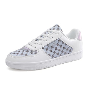 White canvas court sneakers with a patterned panel and iridescent heel detail.