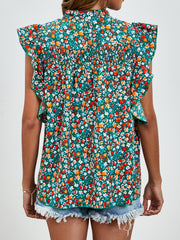 Smocked yoke ruffle sleeve floral blouse in green with red and white flowers.