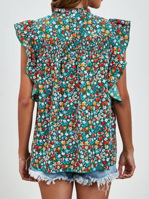 Smocked yoke ruffle sleeve floral blouse in green with red and white flowers.