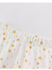 White cotton pajama pants with gold stars and elastic waistband