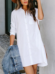 Oversized white cotton shirt dress with button front and curved hem.