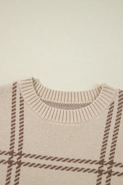 Tan crewneck knit pullover sweater with a brown gridline pattern and ribbed neckline.