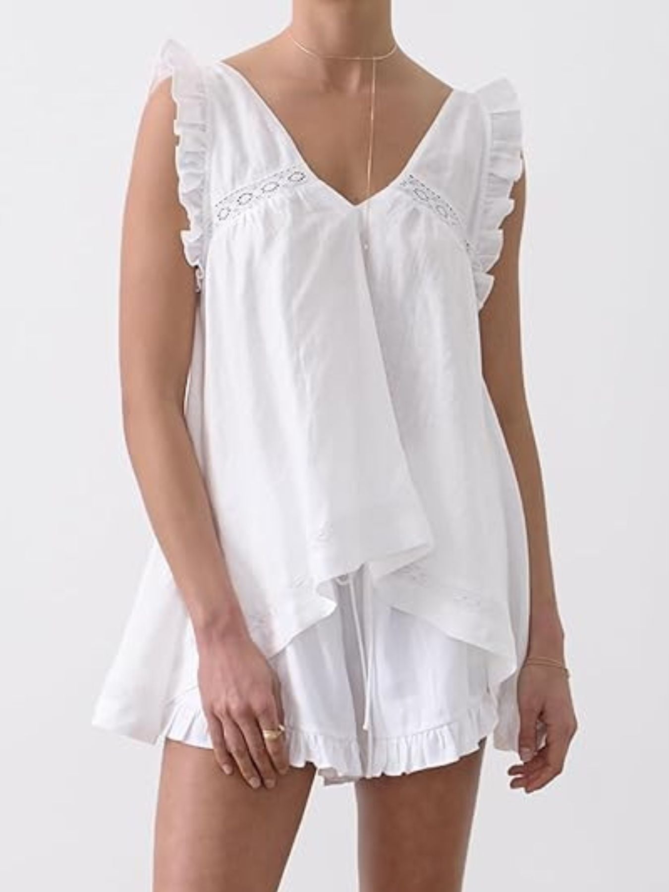 White ruffled V-neck top and shorts set with lace trim and drawstring waist.