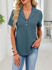 Peacock blue waffle knit button placket polo shirt with collared neckline and short sleeves.