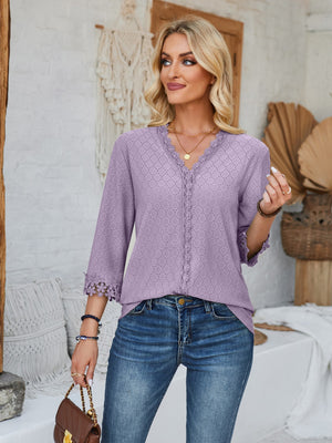 Lavender eyelet trimmed V-neck blouse with lace cuffs and boho styling.