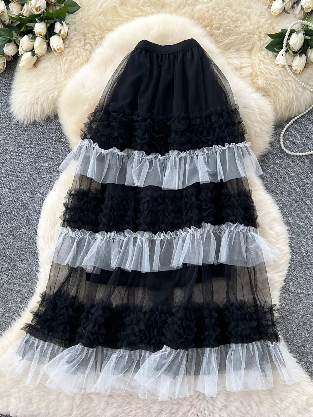 Black tulle tiered ruffle skirt with white ruffle trim detail.