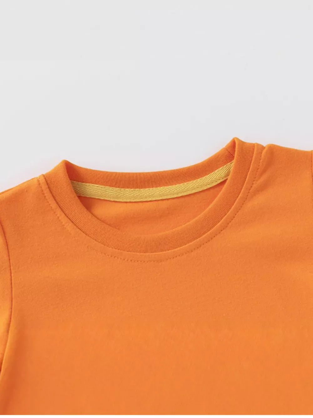 Orange cotton toddler t-shirt with yellow trim detail at the neckline.