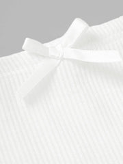 White ribbed mini skirt with a small bow detail.