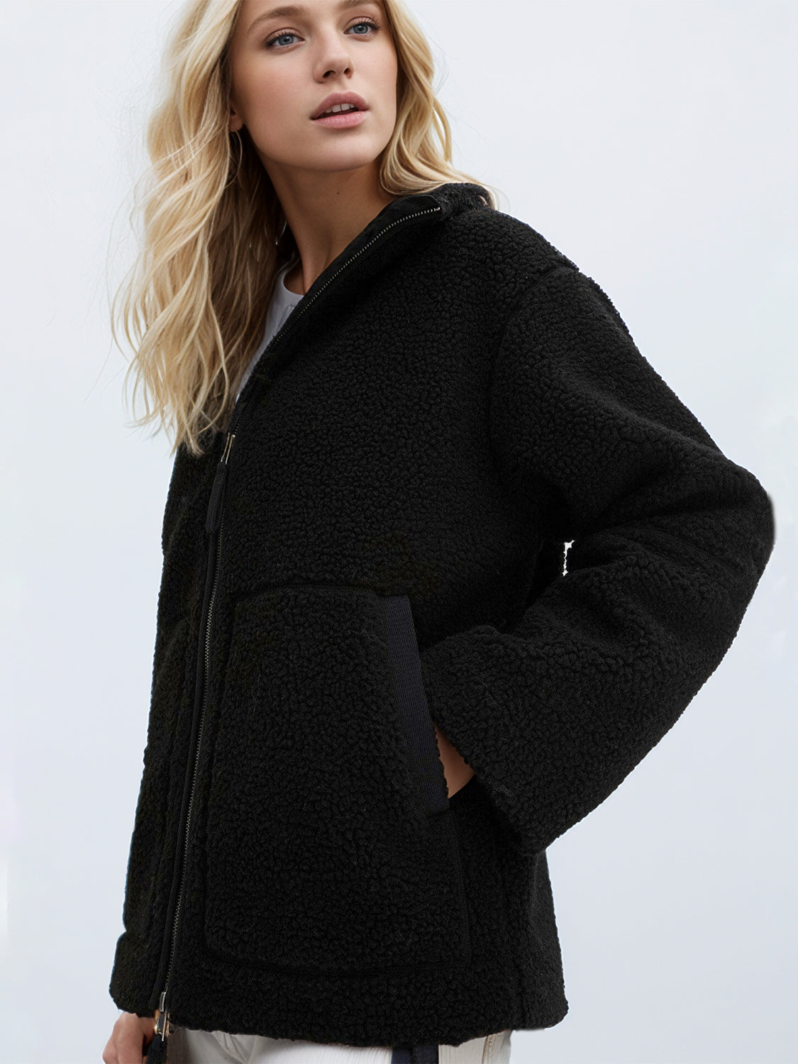 Black sherpa stand-collar jacket with zip closure and pocket detail.