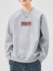 Oversized gray crew-neck sweatshirt with red "DREAM" graphic, cotton blend.