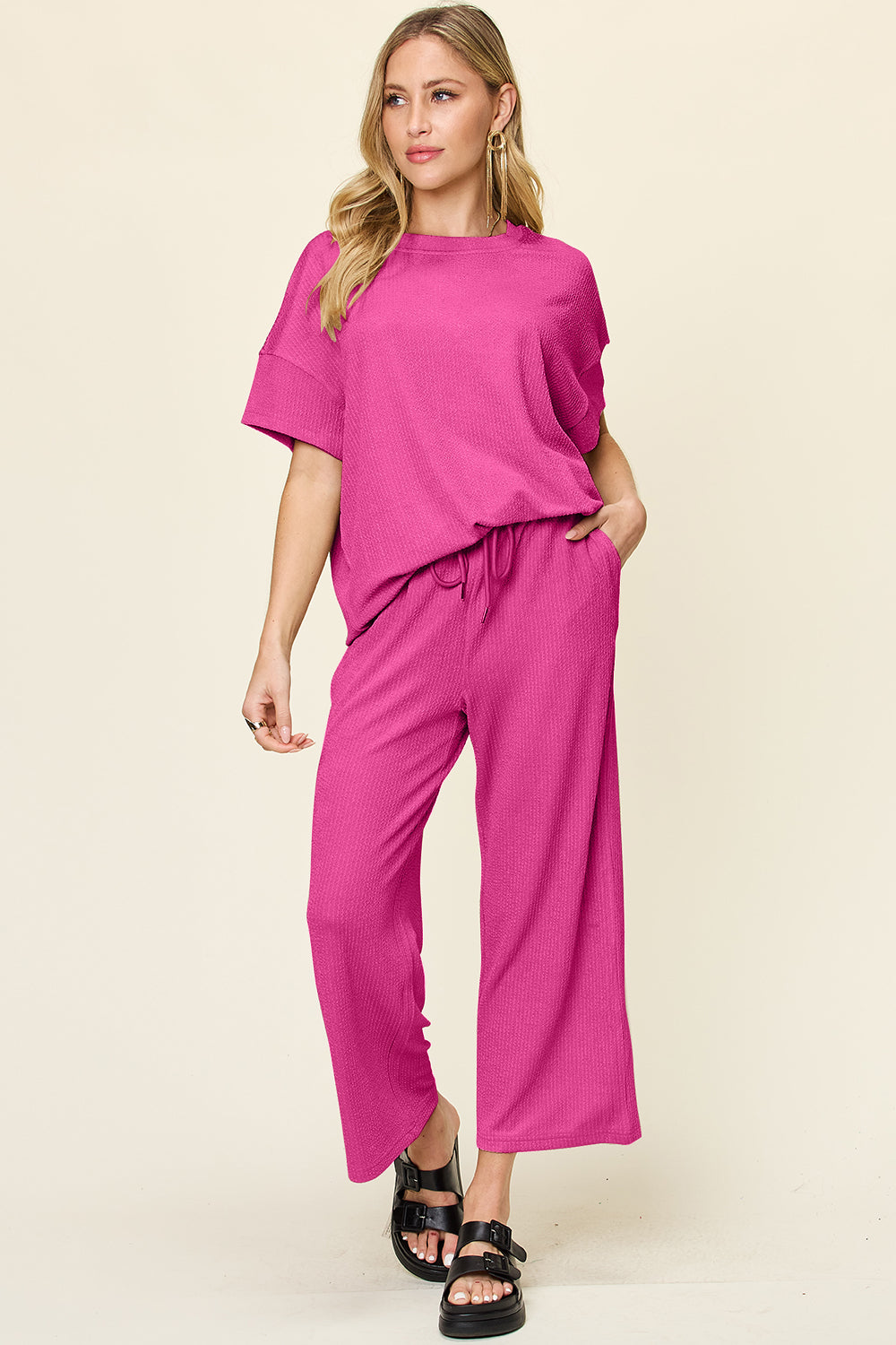 Waffle knit lounge set in hot pink with drawstring pants and short sleeve top.