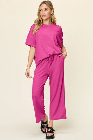 Waffle knit lounge set in hot pink with drawstring pants and short sleeve top.