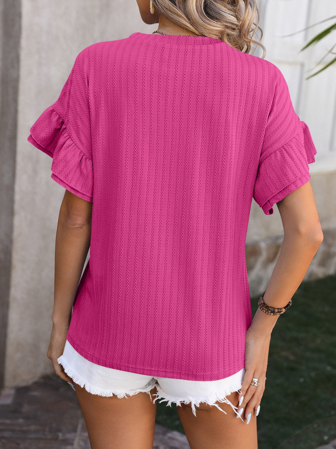 Hot Pink Mandy blouse with textured vertical stripes and flutter sleeves.