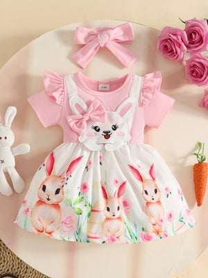 Pink baby dress with bunny applique, ruffled sleeves, and floral bunny print skirt. Includes matching bow headband.