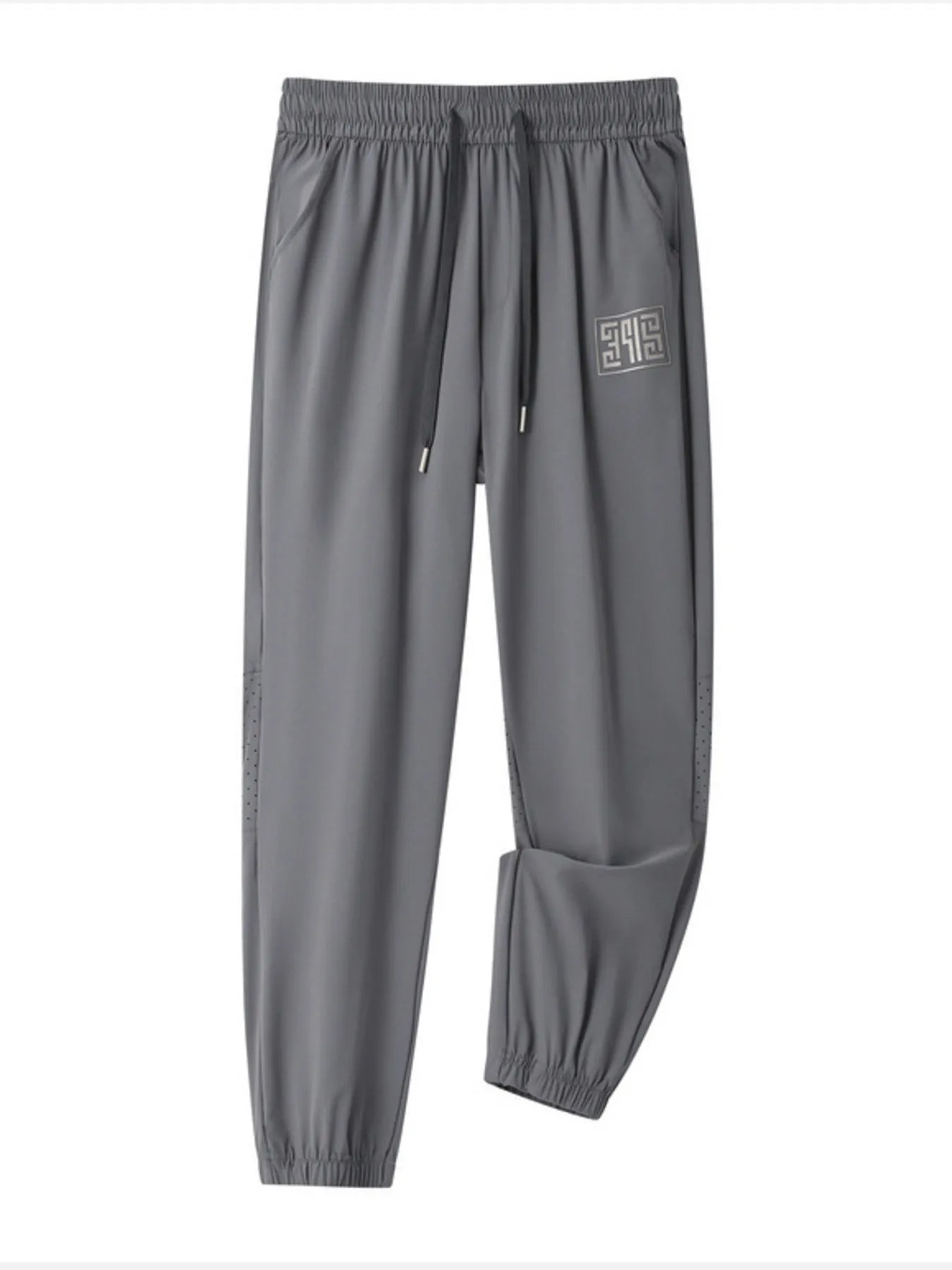Grey casual drawstring joggers with logo detail and perforated side panels.