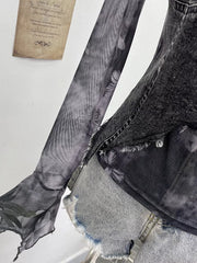 Edgy asymmetrical t-shirt in gray black with sheer butterfly print sleeves and distressed denim accents.