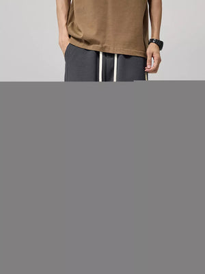 Men's gray drawstring joggers with relaxed fit and white drawcords.