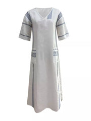White maxi dress with blue stripes, V-neck, short sleeves, and pockets.