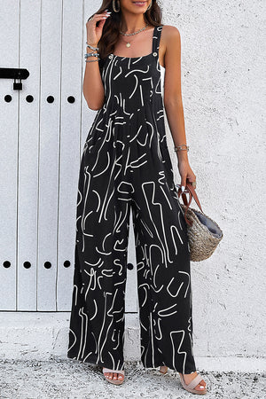 Black wide leg jumpsuit with abstract white scribble print, square neck and adjustable straps.