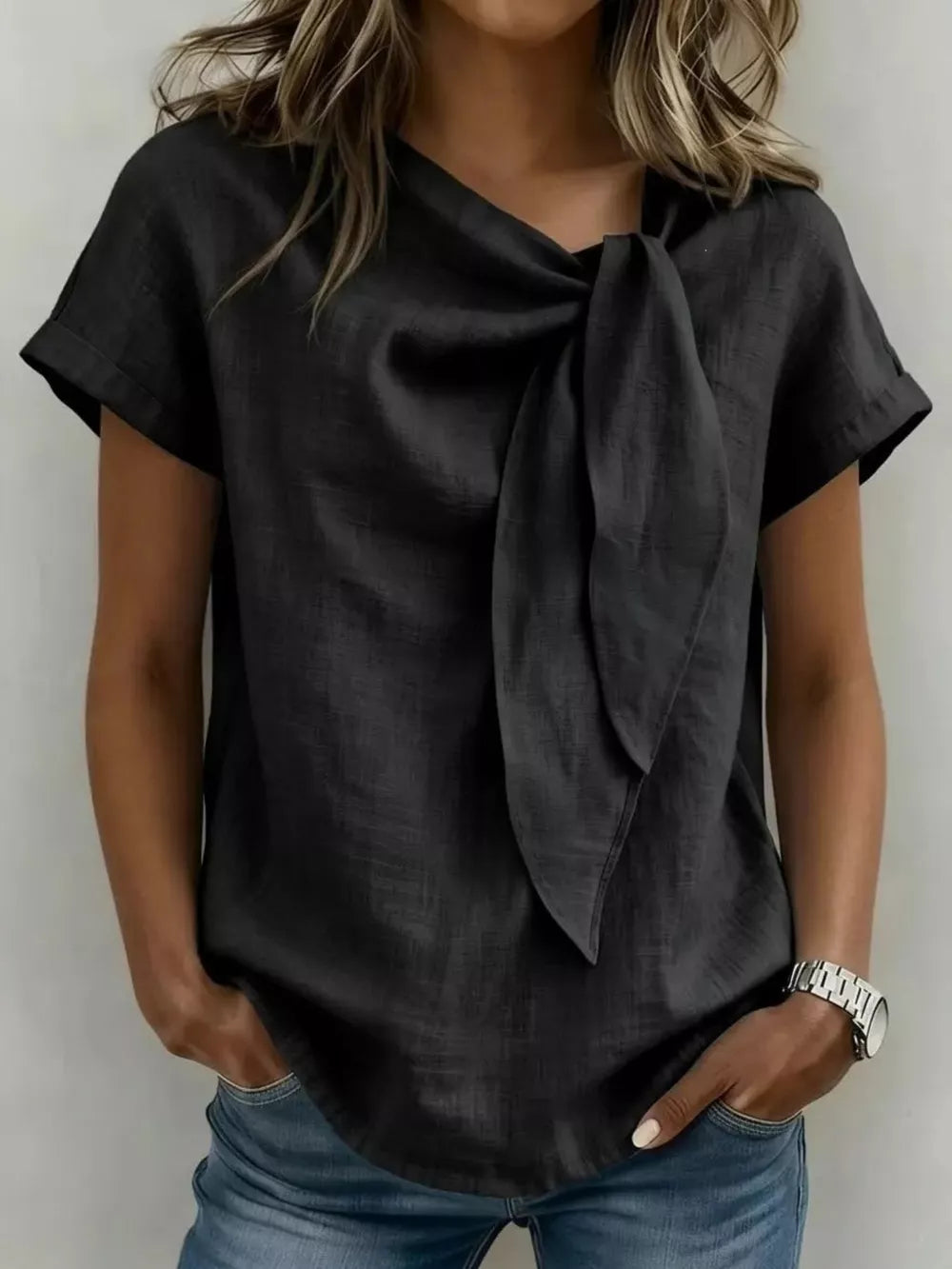 Black relaxed fit shirt with bow-tie neck and short sleeves.
