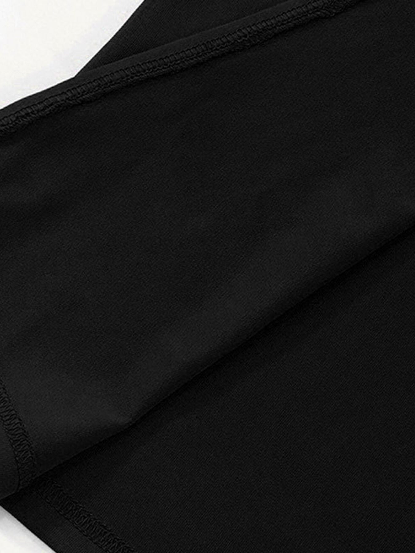 Black off-shoulder maxi dress detail showing fabric texture and stitching.