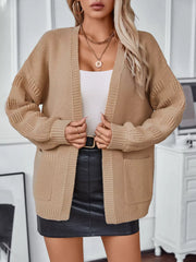 Chunky knit camel open-front cardigan with pockets and textured sleeves.