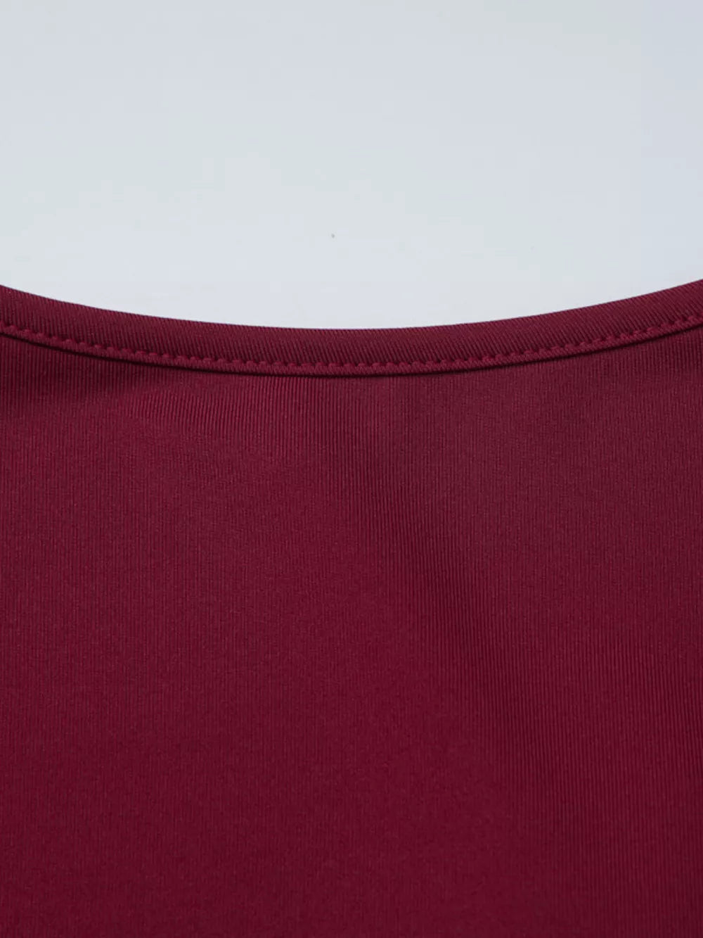 Wine red t-shirt with ribbed texture and delicate lace trim detail at the neckline.