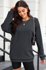 Dark Gray textured ribbed crewneck pullover sweater with long sleeves and a relaxed fit.