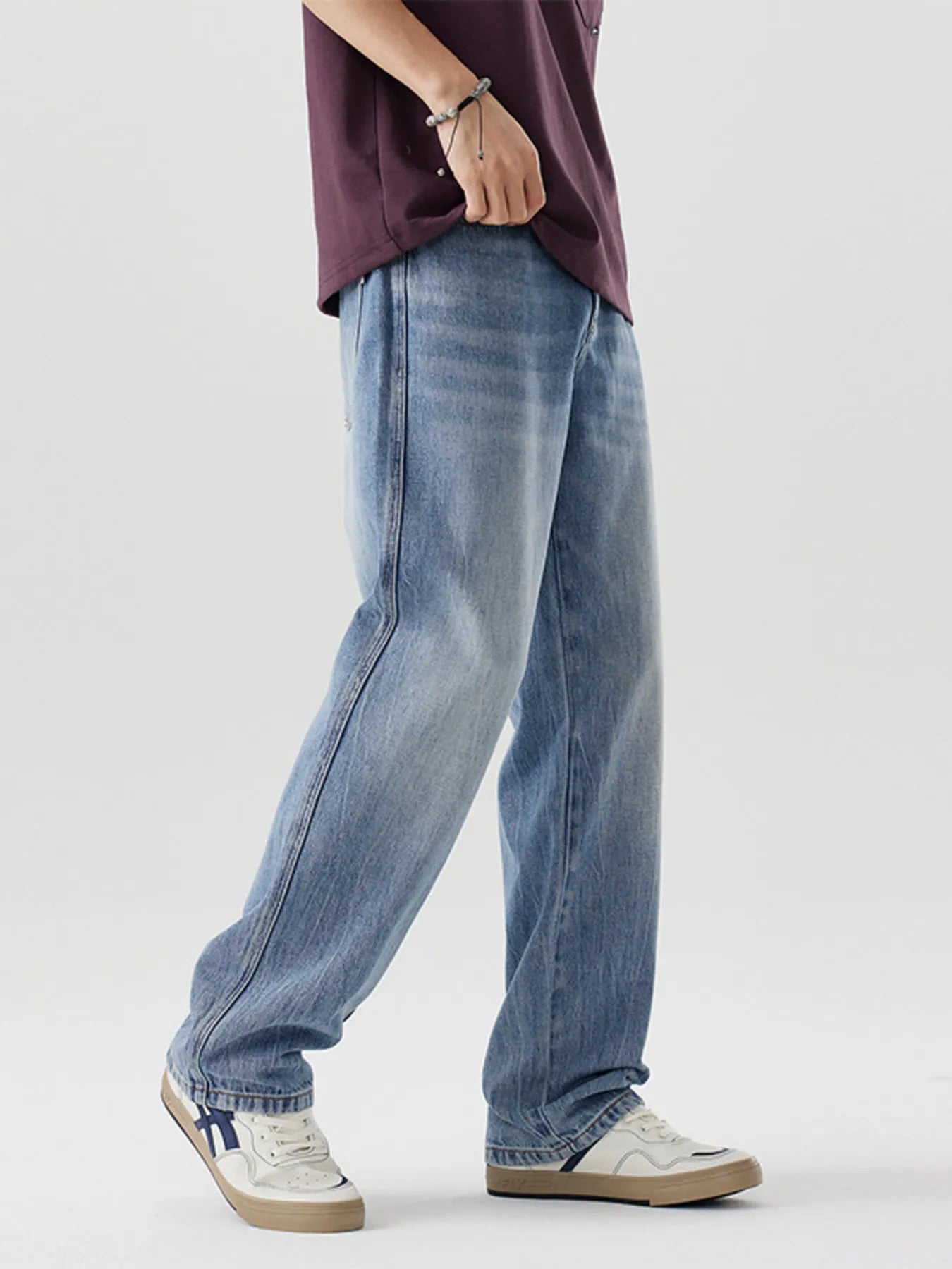 Men's relaxed fit blue washed cotton jeans with a casual style.