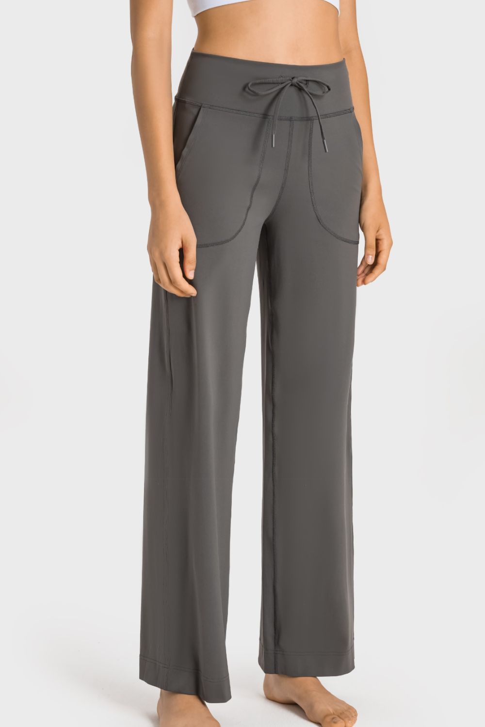 Gray wide-leg lounge joggers with drawstring waist and utility pockets.