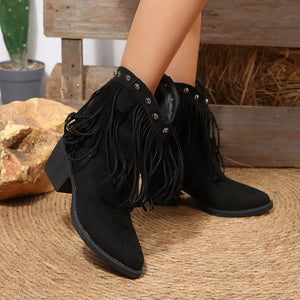 Black suede western boots with fringe and decorative studs on a block heel.