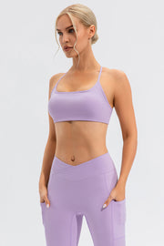 Lilac sports bra with crisscross back straps and scoop neckline.