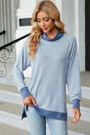 Colorblock raglan turtleneck tunic in heathered light blue with contrasting blue trim and cuffs.