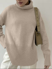 Khaki ribbed turtleneck sweater with flared sleeves and a textured hem.