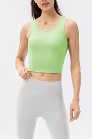 Green active crop top with scoop neck and sculpted seams, sleeveless.
