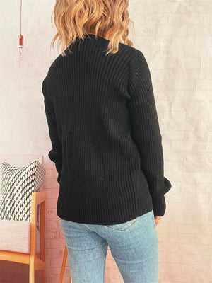 Black ribbed tie-front cardigan with cuffed sleeves, shown from the back.