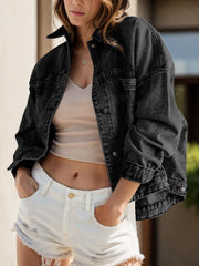Oversized washed black denim trucker jacket with button front and chest pockets.