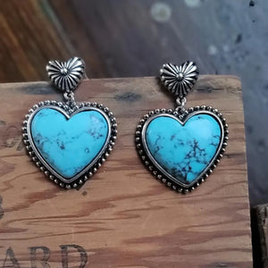 Turquoise heart stone drop earrings with silver beaded trim and sunburst tops.