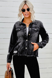 Black distressed denim trucker jacket with frayed hem and ripped details.