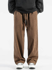 Brown corduroy wide-leg sweatpants with drawstring waist and pockets.