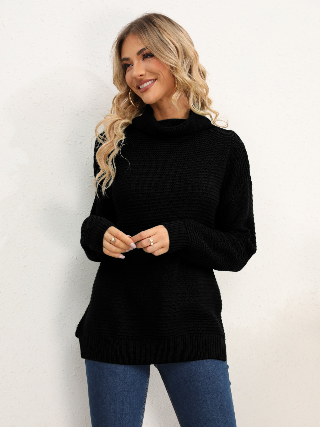 Black textured knit oversized turtleneck pullover sweater with ribbed details.