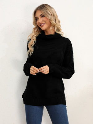 Black textured knit oversized turtleneck pullover sweater with ribbed details.