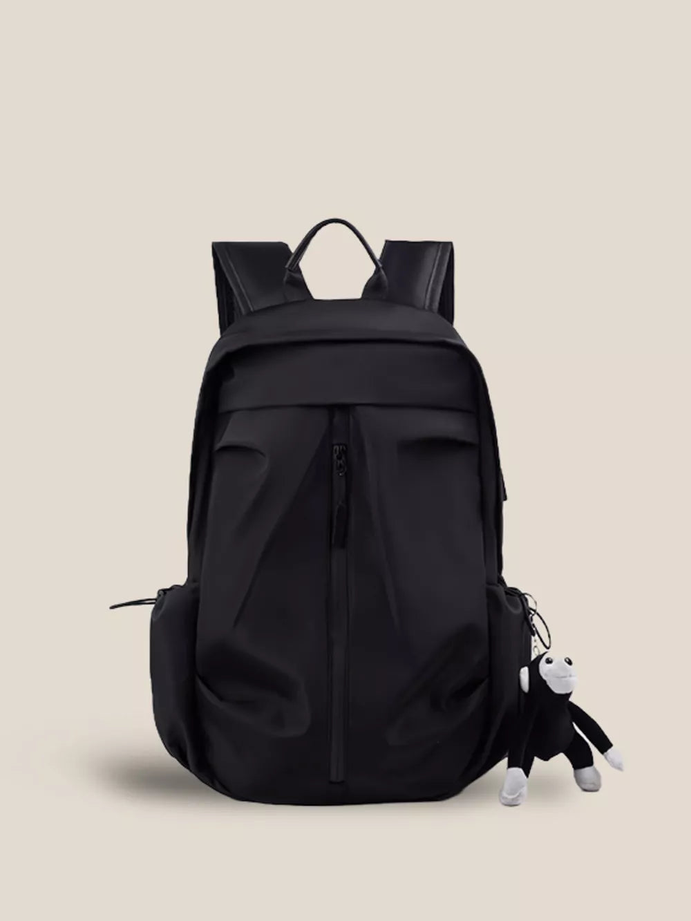 Black nylon drawstring backpack with zip pockets and monkey charm