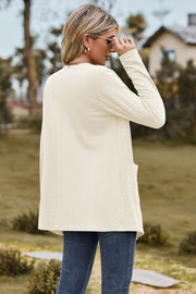 Cream textured open-front cardigan with pockets and long sleeves.