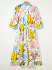 Midi dress with 3/4 sleeves, elastic waist, and tiered hem in a whimsical floral doodle print.