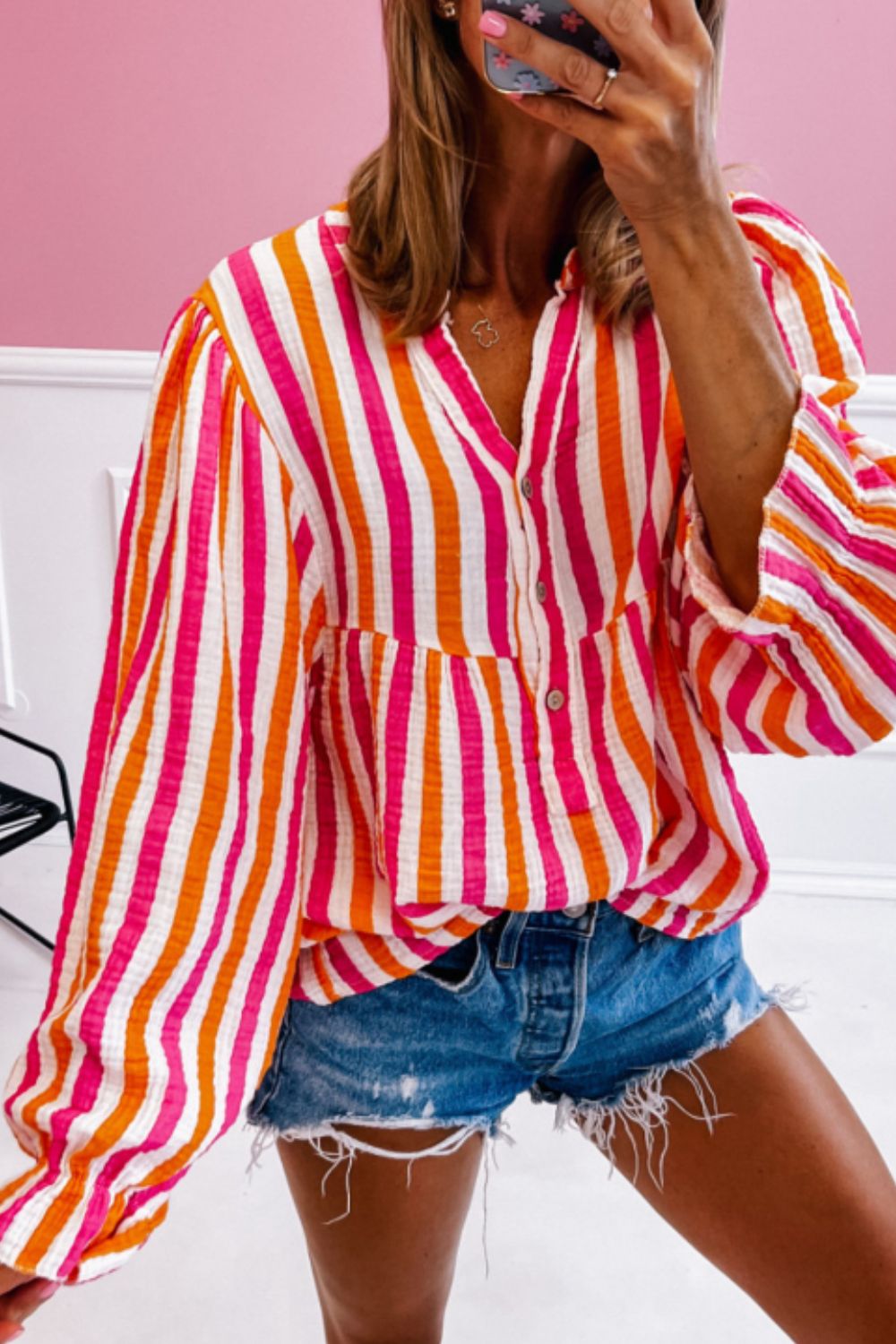 Textured stripe blouse in red with gathered sleeves and a V-neck.