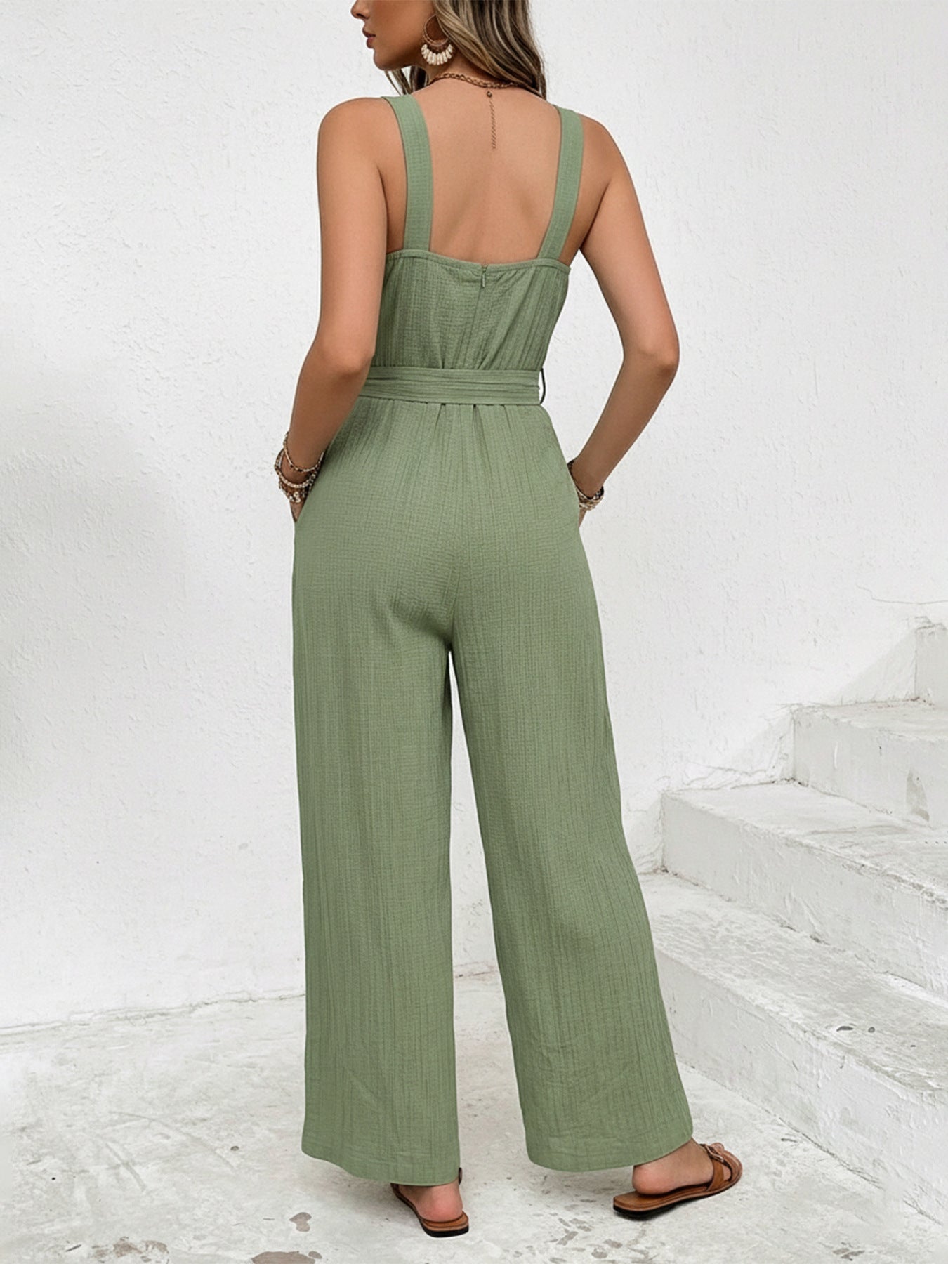 Green crinkled texture tie waist wide leg maternity jumpsuit with square neckline and wide straps.